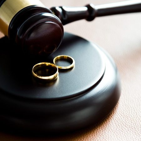 Gavel and wedding rings, for divorce concept.